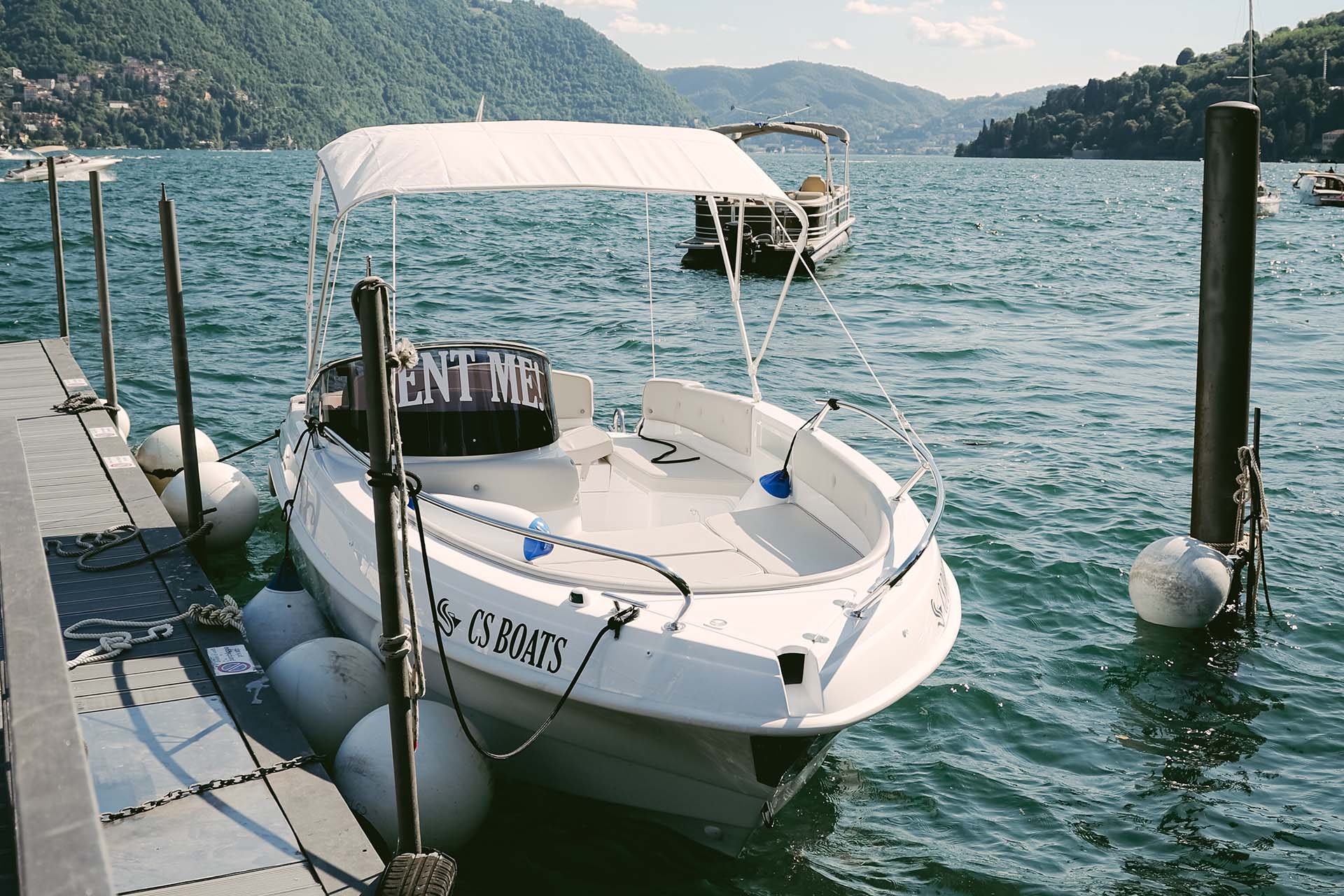 Luxury Venetian taxi boat cruising on Lake Como at sunset
